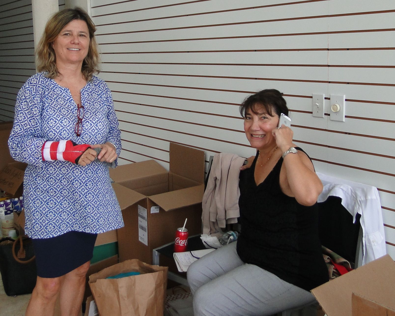 Helena Iturralde watches as Nancy Gamwell organizes the schedule for volunteers